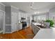 Bright kitchen with a large center island, white cabinets, stainless appliances and hardwood floors at 3424 English Cir, Willow Springs, NC 27592