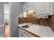 View of a Butler's pantry featuring a sink, mosaic tile backsplash, and white cabinetry at 3424 English Cir, Willow Springs, NC 27592