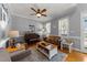 Bright living room featuring hardwood floors, a ceiling fan, and lots of natural light at 3424 English Cir, Willow Springs, NC 27592
