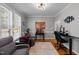 Well-lit home office with hardwood floors, modern furniture, and ample natural light at 3424 English Cir, Willow Springs, NC 27592