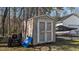 Outdoor shed with double doors, providing ample storage space for tools and equipment at 3424 English Cir, Willow Springs, NC 27592