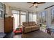 Sunroom featuring lots of windows, hardwood floors, a ceiling fan, and a comfortable seating area at 3424 English Cir, Willow Springs, NC 27592