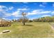 Spacious backyard featuring a wooden deck, mature tree, and ample green space, great for outdoor enjoyment at 3533 N Way Dr, Zebulon, NC 27597