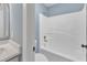 Stylish bathroom with light blue walls, shower-tub combo, and granite countertops at 3533 N Way Dr, Zebulon, NC 27597