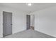 A bedroom featuring gray carpet and two gray doors at 3533 N Way Dr, Zebulon, NC 27597