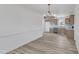 Spacious dining room with modern chandelier and wood flooring, adjacent to the kitchen at 3533 N Way Dr, Zebulon, NC 27597