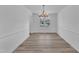 Open dining room layout with modern chandelier and a view of the neighborhood at 3533 N Way Dr, Zebulon, NC 27597