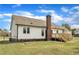 Back of house showing deck, chimney and a partial view of the backyard at 3533 N Way Dr, Zebulon, NC 27597