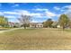 Large front yard with long gravel driveway and mature trees at 3533 N Way Dr, Zebulon, NC 27597