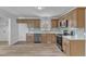 Modern kitchen with stainless steel appliances, quartz countertops, and natural wood cabinets at 3533 N Way Dr, Zebulon, NC 27597