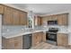 Modern kitchen with stainless steel appliances, quartz countertops, and natural wood cabinets at 3533 N Way Dr, Zebulon, NC 27597