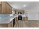 Modern kitchen with stainless steel appliances, quartz countertops, and natural wood cabinets at 3533 N Way Dr, Zebulon, NC 27597
