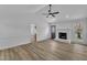 Bright living room features fireplace, modern ceiling fan, and ample space at 3533 N Way Dr, Zebulon, NC 27597