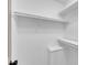 A large and empty white walk-in closet featuring shelving units at 3533 N Way Dr, Zebulon, NC 27597