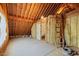 An unfinished attic with exposed beams, insulation, and a ladder at 367 Windham Way, Clayton, NC 27527