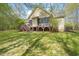 Expansive backyard features a screened porch, wooden deck with stairs, and lush green grass at 367 Windham Way, Clayton, NC 27527