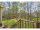 Spacious backyard featuring lush green grass, trees, and a dark metal fence at 367 Windham Way, Clayton, NC 27527