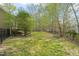 Expansive backyard with lush green grass and a dark metal fence surrounding the property at 367 Windham Way, Clayton, NC 27527