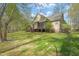 Expansive backyard features a screened porch, wooden deck with stairs, and lush green grass at 367 Windham Way, Clayton, NC 27527