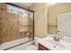 Cozy bathroom featuring a shower over tub combo, tile surround and single vanity at 367 Windham Way, Clayton, NC 27527