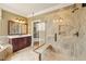 Primary bathroom featuring double vanity, glass shower door and separate jacuzzi tub at 367 Windham Way, Clayton, NC 27527