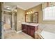 Well-appointed bathroom featuring a single vanity, soaking tub, and a tiled shower with glass door at 367 Windham Way, Clayton, NC 27527