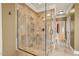Tiled shower stall with glass door and overhead rain shower faucet. Hallway view at 367 Windham Way, Clayton, NC 27527
