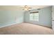 Bedroom featuring neutral carpet, a large window, and light blue walls at 367 Windham Way, Clayton, NC 27527