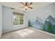 Bright bedroom features neutral carpet and mountain mural wall design at 367 Windham Way, Clayton, NC 27527