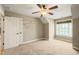Spacious bedroom with a ceiling fan, and a large window for natural light at 367 Windham Way, Clayton, NC 27527