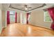 Spacious bedroom featuring tray ceilings, large windows, and hardwood flooring, offering ample natural light at 367 Windham Way, Clayton, NC 27527
