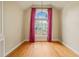 Charming bedroom with a vaulted ceiling, hardwood flooring, and a large window dressed with elegant drapes at 367 Windham Way, Clayton, NC 27527
