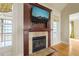 Close-up of a fireplace with custom wood trim and mantle, offering a focal point for cozy gatherings at 367 Windham Way, Clayton, NC 27527