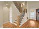 Elegant foyer with hardwood floors, decorative staircase, and natural light, creating an inviting entrance at 367 Windham Way, Clayton, NC 27527