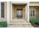 Inviting front porch with stone accents, columns, and a decorative front door, creating a warm welcome at 367 Windham Way, Clayton, NC 27527