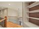 Upper level landing with wooden floors and convenient built-in shelving at 367 Windham Way, Clayton, NC 27527