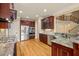 Well-equipped kitchen with stainless steel appliances, wood cabinetry, and an island with granite countertops at 367 Windham Way, Clayton, NC 27527