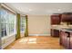 Eat-in kitchen with light filled windows and dark wood cabinetry at 367 Windham Way, Clayton, NC 27527