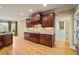 Kitchen features custom cabinets, a gas cooktop, and granite countertops at 367 Windham Way, Clayton, NC 27527