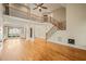Bright, open-concept living space with hardwood floors, a staircase, and great natural light from large windows at 367 Windham Way, Clayton, NC 27527