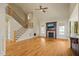 Open living room with hardwood floors, fireplace, and large windows, creating a cozy and bright space at 367 Windham Way, Clayton, NC 27527