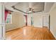 Large main bedroom featuring hardwood floors, two windows and a ceiling fan at 367 Windham Way, Clayton, NC 27527
