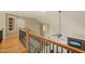 Upper level landing with ornate staircase, hardwood floors and decorative railings at 367 Windham Way, Clayton, NC 27527