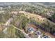 Aerial view showcasing a home nestled within a forest with a neighboring golf course at 370 Chapel Ridge Dr, Pittsboro, NC 27312