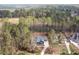 Stunning aerial view of a modern home nestled among lush trees and manicured lawns in a quiet, wooded neighborhood at 370 Chapel Ridge Dr, Pittsboro, NC 27312