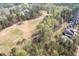 Scenic aerial shot of a neighborhood featuring lush trees, manicured lawns, and homes with beautiful landscaping at 370 Chapel Ridge Dr, Pittsboro, NC 27312