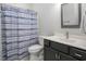 Classic bathroom featuring a shower with a patterned curtain and a gray vanity at 370 Chapel Ridge Dr, Pittsboro, NC 27312