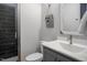 Bathroom with tiled shower, white marble countertop, and decorative vintage accent at 370 Chapel Ridge Dr, Pittsboro, NC 27312
