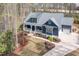 Charming exterior elevation of a modern home with a covered porch, manicured lawn, and attached garage at 370 Chapel Ridge Dr, Pittsboro, NC 27312