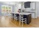 Modern kitchen with a large island and an adjacent dining area at 370 Chapel Ridge Dr, Pittsboro, NC 27312